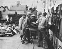 Transferring wounded from 
an LCI to a British hospital ship off Anzio