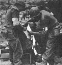 Treating 88th division 
casualty at a forward aid station, May 1944