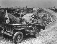 Giving plasma to a 1st 
Special Service Force soldier while he is being evacuated by jeep to a collecting station