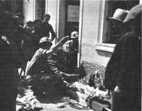 Wounded German receiving 
plasma in Villafranca, April 1945