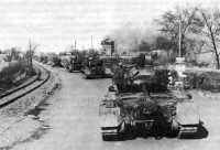 Convoy of Pershing tanks 
moves through a German town