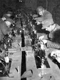 German prisoners at Rheims 
repairing captured clothing